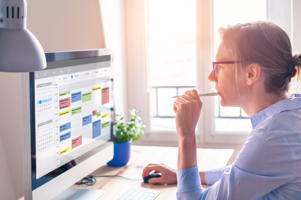 woman on computer managing her calendar