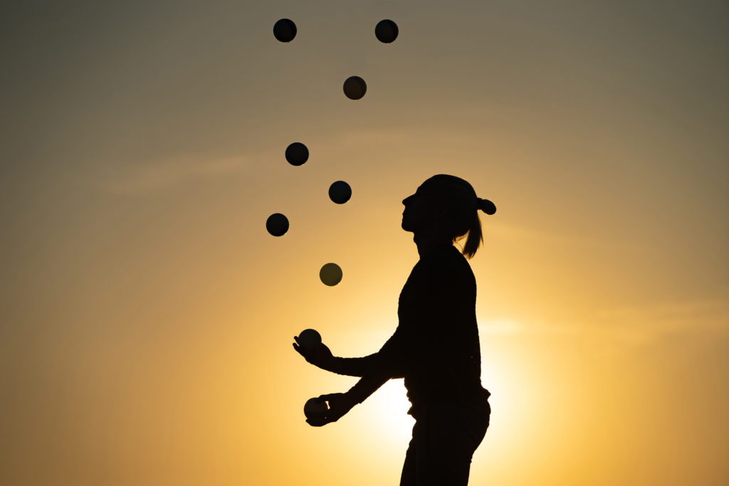 Juggler with balls in the air representing LiquidPlanner project management