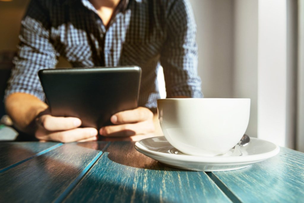 man looking at resources on tablet