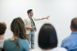 man excelling in his role as a leader and presenter