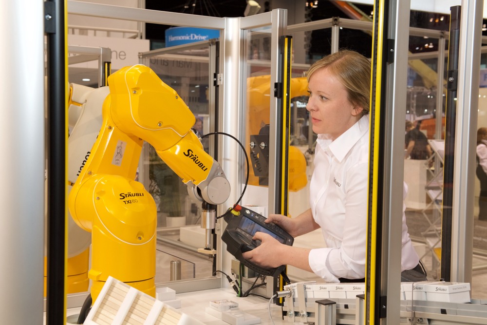 An engineer operating the Stäubli TX2 60 at Automate trade show.