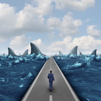 project manager walking through a sea of sharks