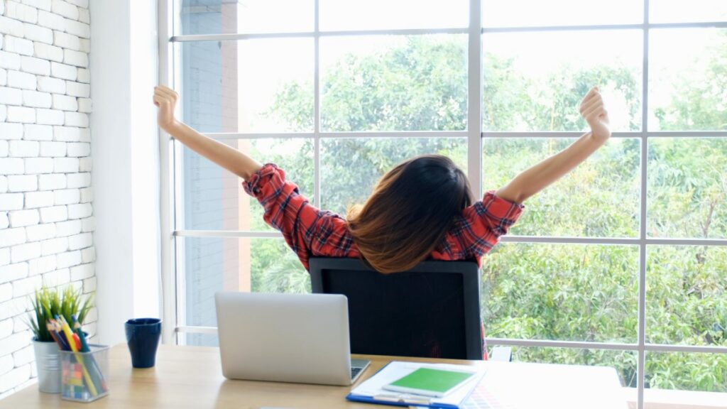 project manager taking a break in her work day by stretching arms