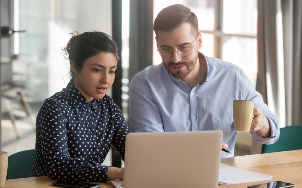 consultants working together at laptop