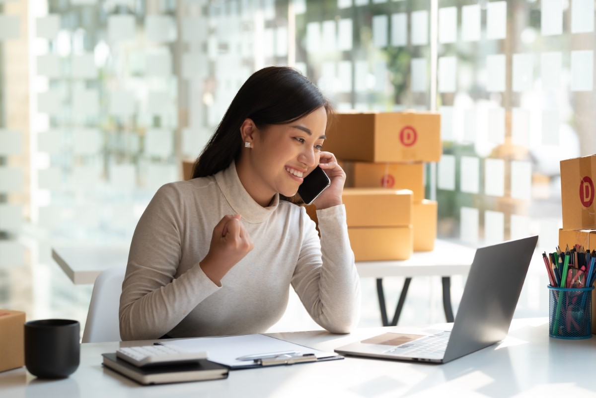 excited employee taking on phone