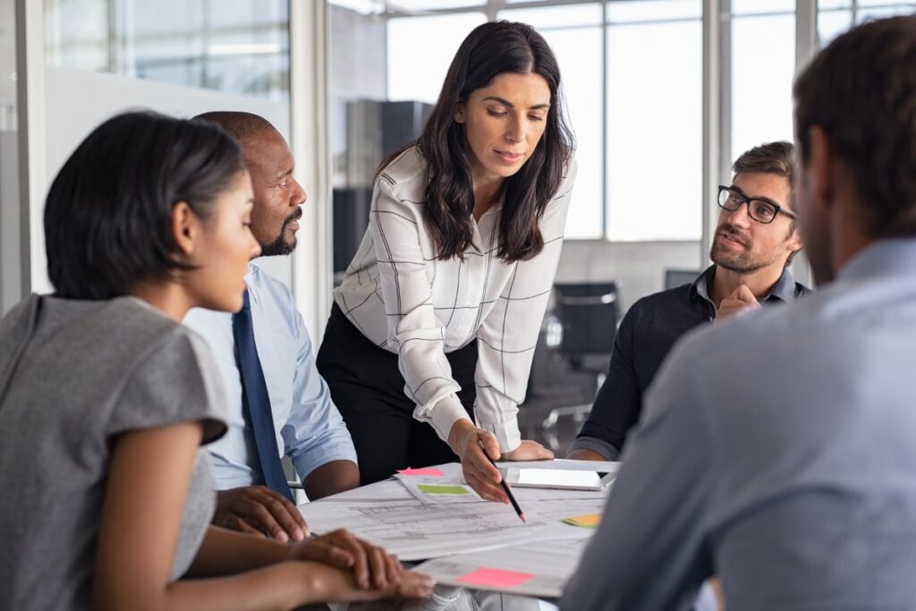 woman leading team meeting with charts