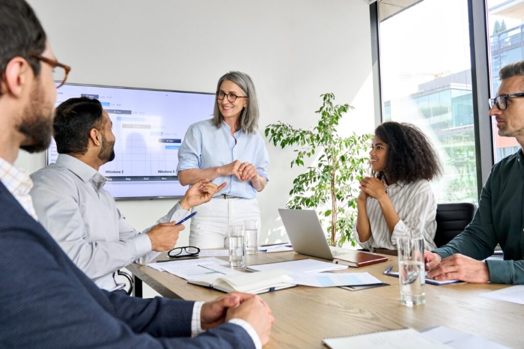 woman stands and receives feedback from team member