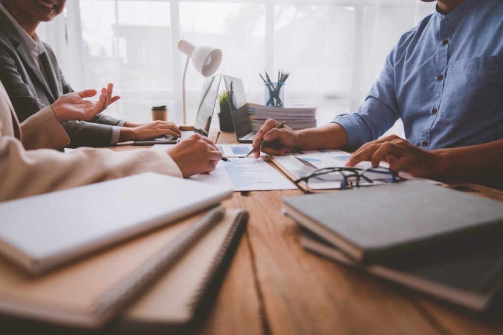 three people meeting to review portfolio projects