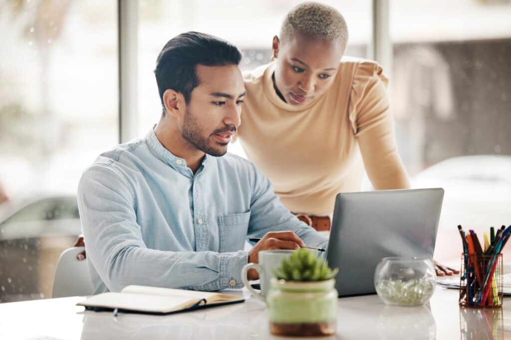 two people reviewing a project plan on a computer